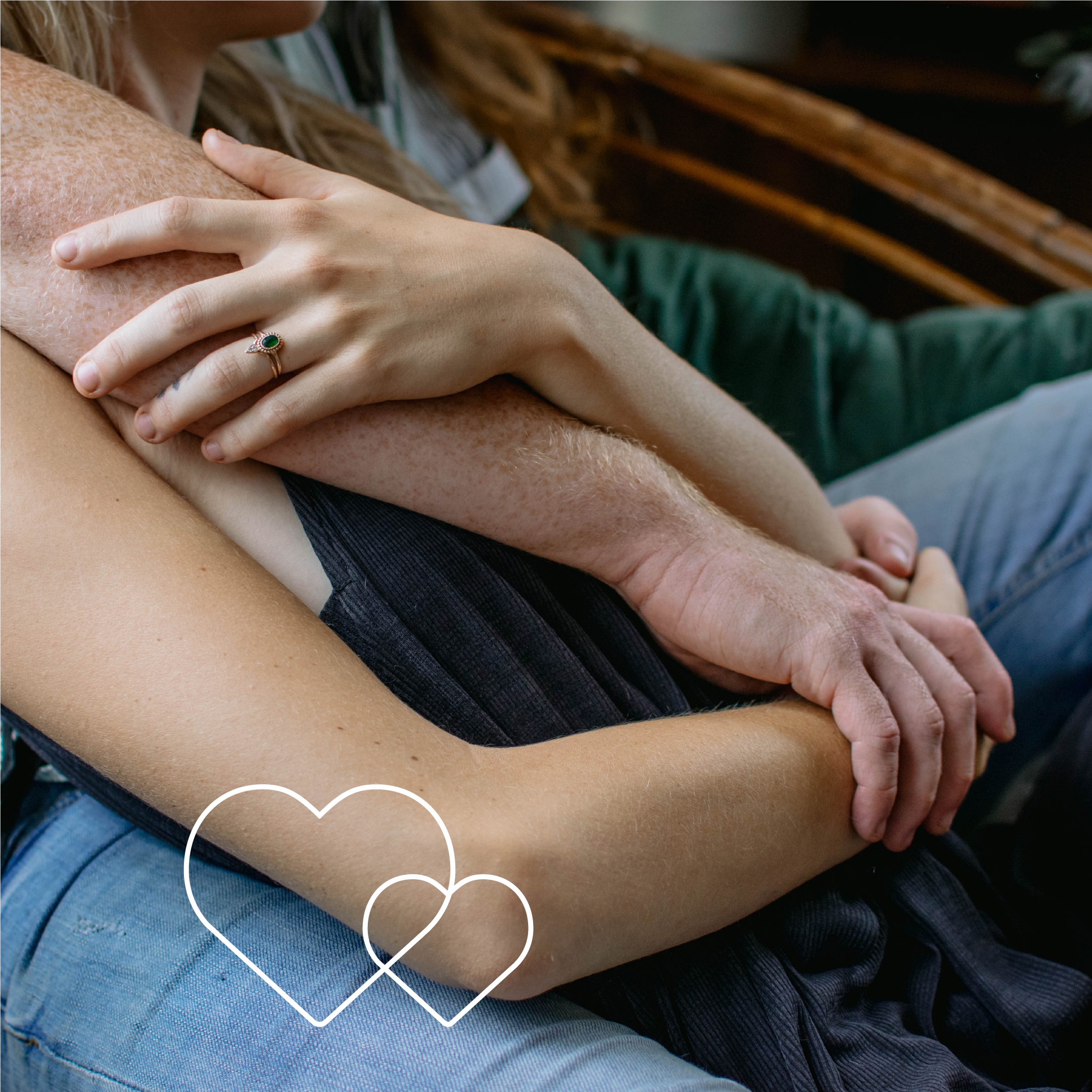 Image of arms intertwined while two people cuddle